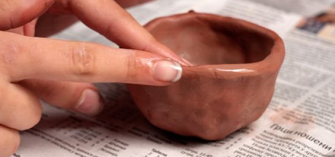 hand making a pinch pot