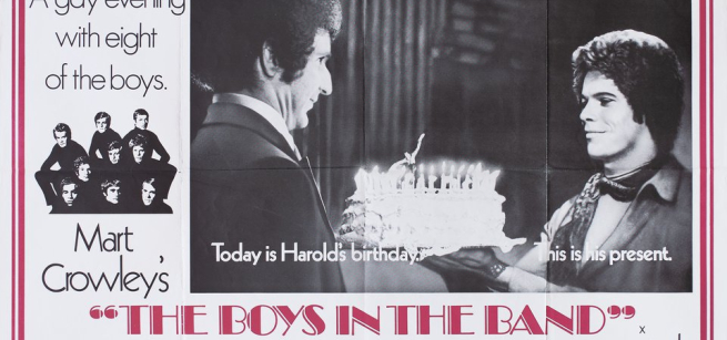 one man presents another man a cake 