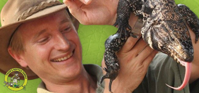 Thor holds a lizard sticking its tongue out