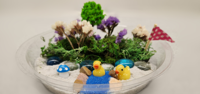 A miniature scene with dried botanical elements and plastic figurines.