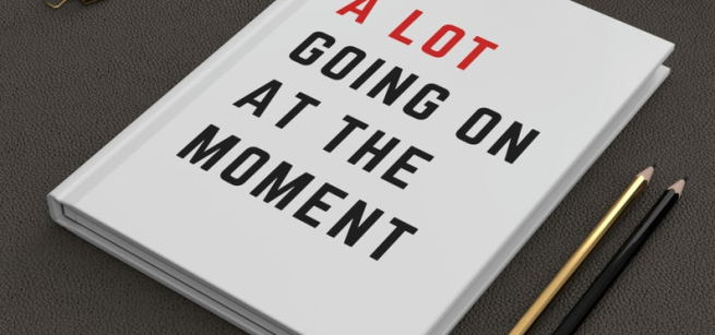 JOURNAL WITH THE WORDS A LOT GOING ON AT THE MOMENT ON THE FRONT