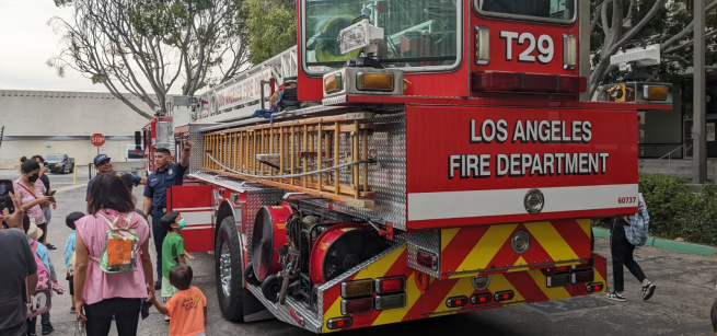 Children explore a firetruck outside of the Pio Pico library