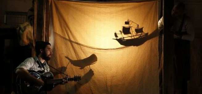 performance of shadow puppets and guitar