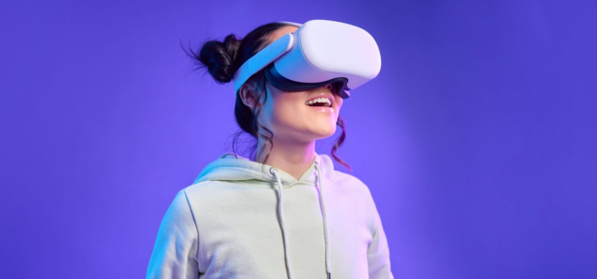 purple background with upper body of a woman wearing a white sweatshirt and white virutal reality goggles