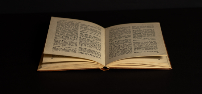 An old book on a black backdrop