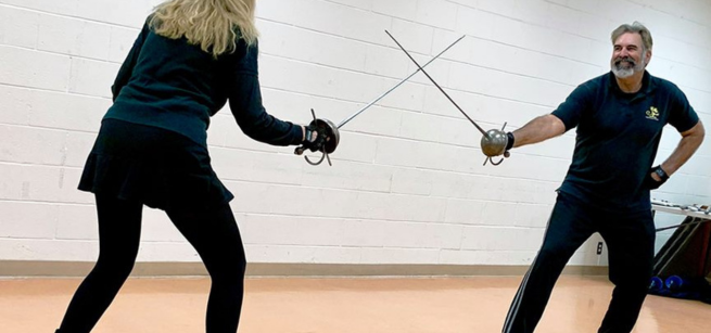 People sword fighting.