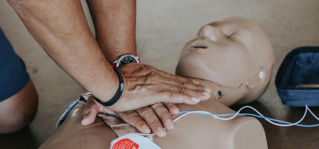 person performing CPR on a dummy
