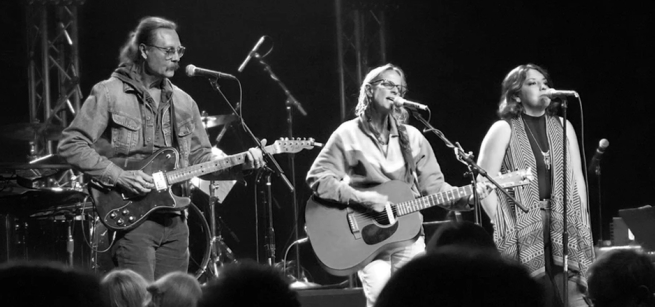three musicians play on stage