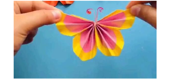hands holding butterfly paper craft