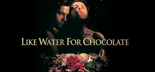 young man and woman holding tray with roses, grapes, oranges, vegetables