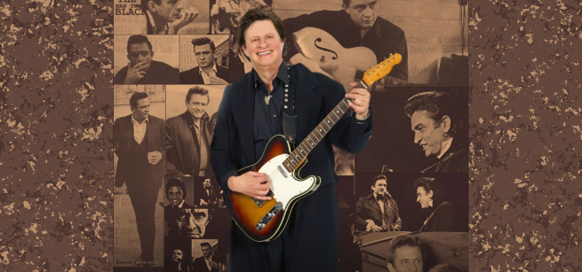 Michael Jay holding his guitar