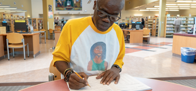 Adult learner doing work in the library.