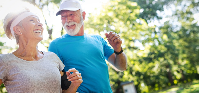 older couple jogging with man wearing a blue shirt and woman wearing a white shirt