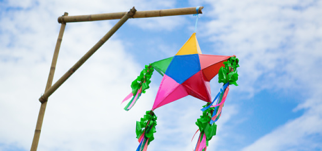 parol hanging on bamboo with cloudy blue sky in the background