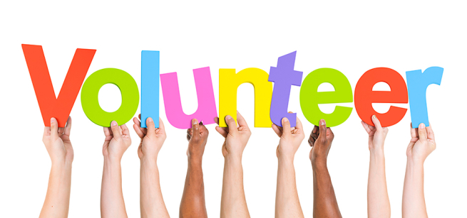 arms holding up the word volunteer