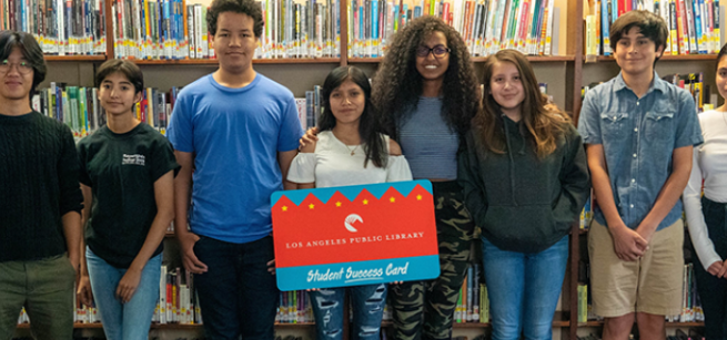 Teens standing near Student Success library card