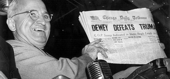 Harry Truman holds up a newspaper with the heading "Dewey Defeats Truman"