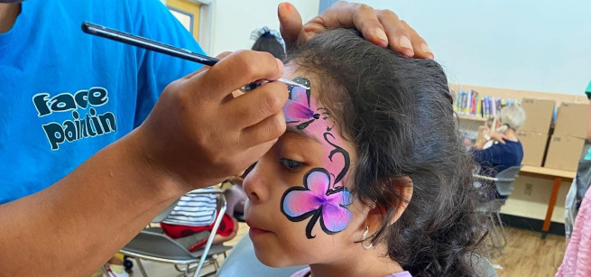child having their face painted