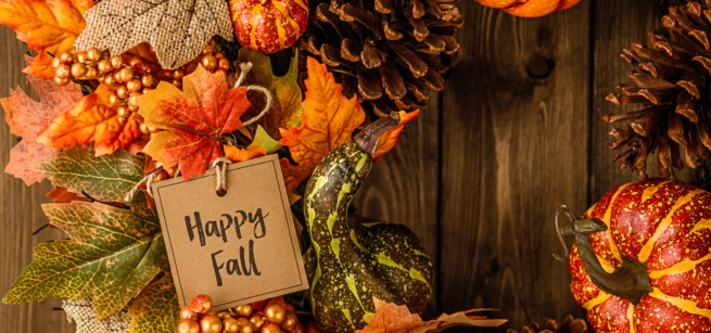 Fall wreath decorated in various colors of leaves, beads, pine cones and various small squashes