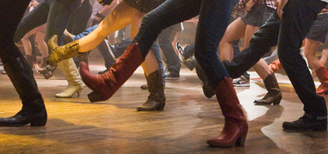 image of a group of people in cowboy boots line dancing