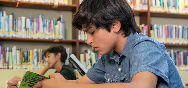 Teen reading at the library