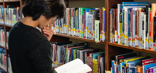 teen reading at the library