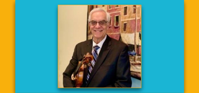 Musician Paul Stein is shown holding his violin.