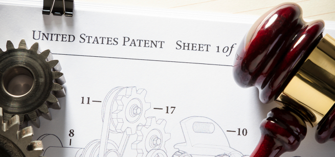 Gears and a gavel rest on a United States patent