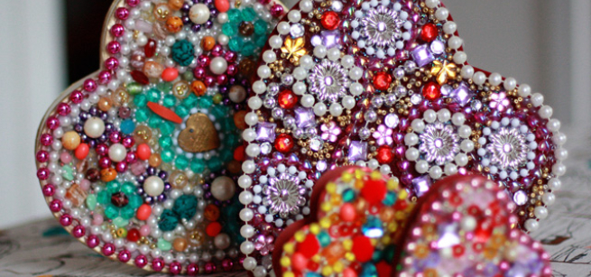 four heart shaped boxes decorated with beads