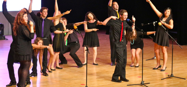 An image of a group singing on stage