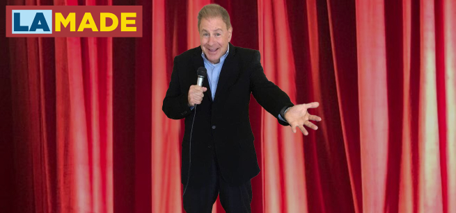 Marty Fidelman in front of a red curtain