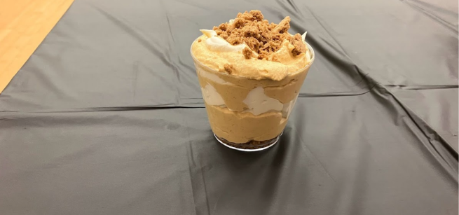 Pumpkin pie parfait topped with cookie crumbs