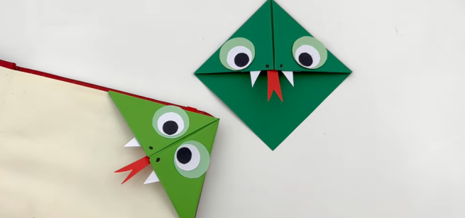 Two green paper snake bookmarks, cute with big eyes, teeth, and red tongue. 