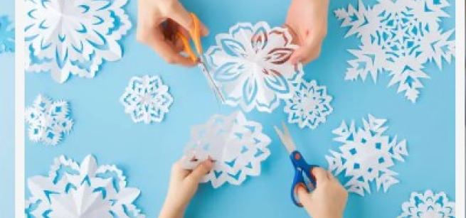 2 sets of hands cutting paper snowflakes