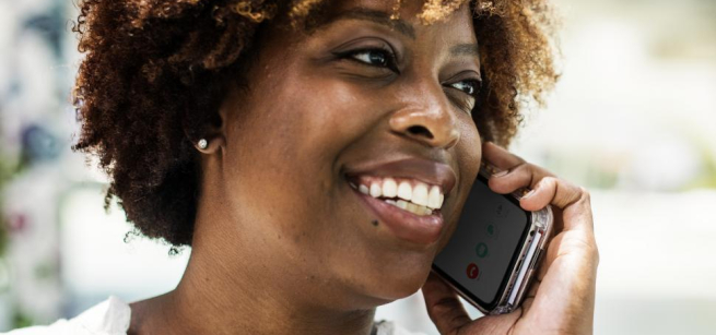 a person looking to their left speaking on a mobile phone