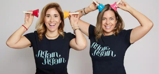 two performers holding bells to their heads
