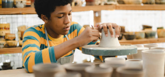 Teen boy sculpting ceramics