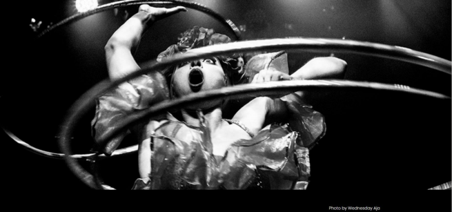 A black and white photograph of the female acrobat