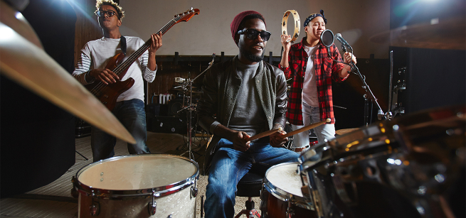 Three young adults play different instruments