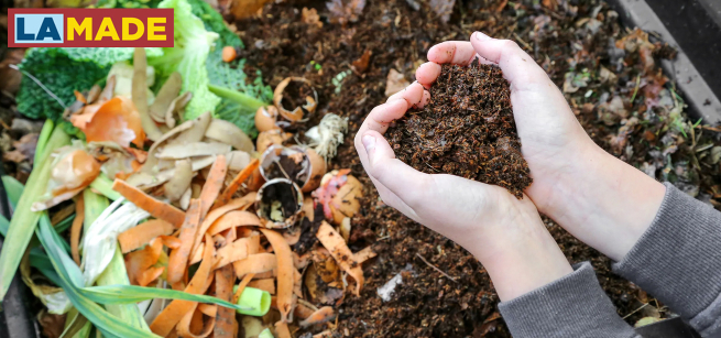 compost bin with hands holding dirt