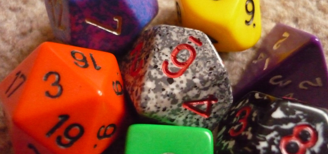A close-up photograph of various colorful multi-sided dice