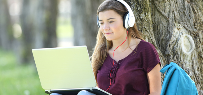 student working on laptop outside