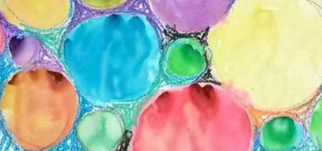 Abstract crayon resist drawing of colorful circles.