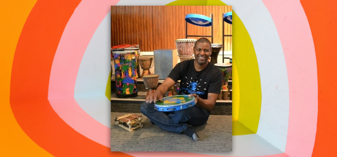 A photo of Delton Davis with several drums of different shapes and sizes
