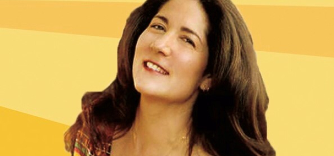 Headshot of brunette woman in striped top