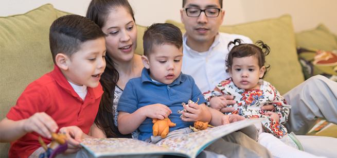 Family of 5 reading together. 