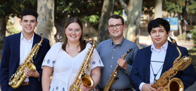 Four adults holding saxophones
