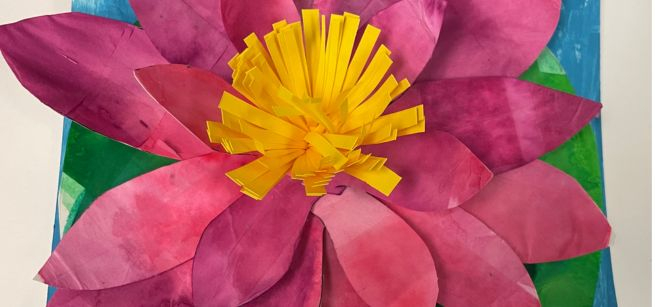 A Lilly Pad made out of bright magenta and yellow paper.