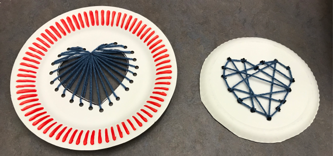 Paper plates decorated with yarn in the shape of a heart