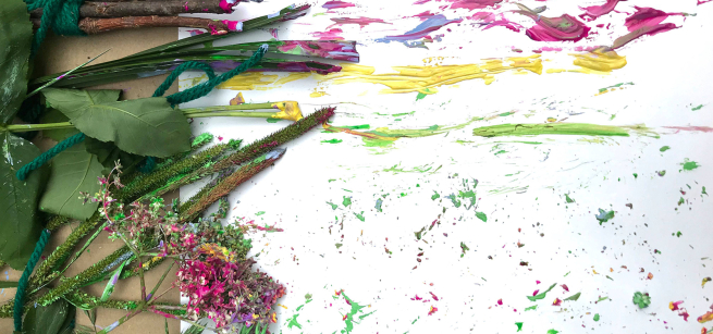 twigs, leaves, and flower stems used as paint brushes on white paper